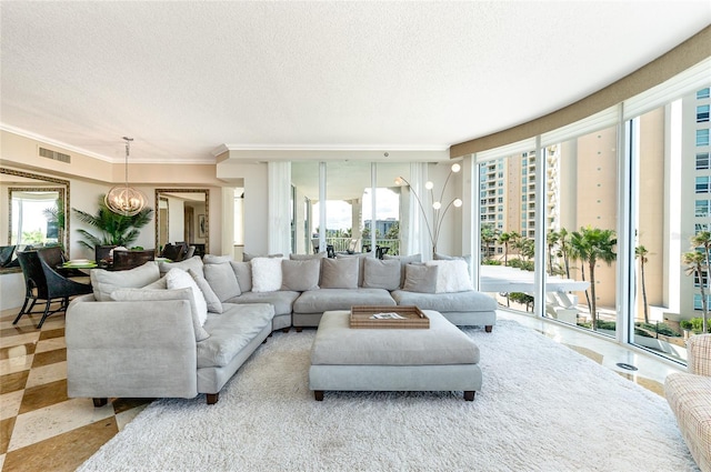 living room with ornamental molding, a textured ceiling, and a healthy amount of sunlight