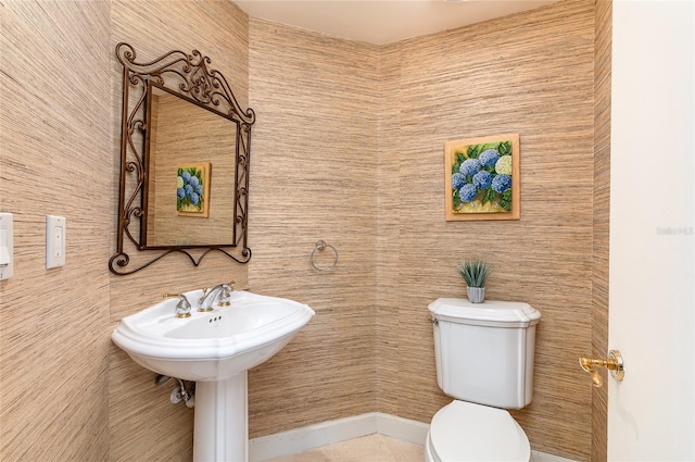 bathroom with tile patterned floors, toilet, and tile walls