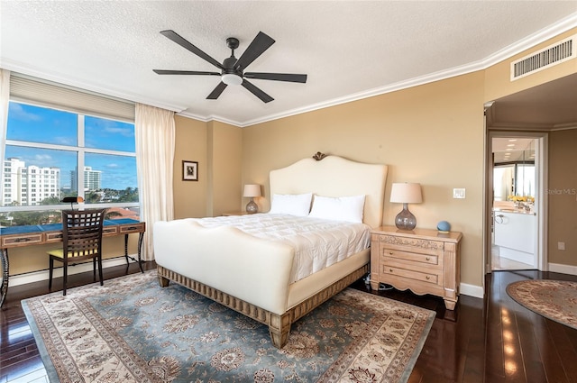 bedroom with ceiling fan, dark hardwood / wood-style flooring, a textured ceiling, and ornamental molding