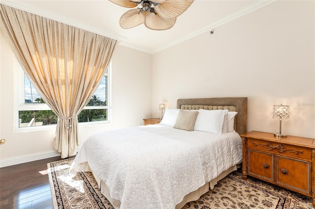 bedroom with dark hardwood / wood-style floors, ceiling fan, and ornamental molding