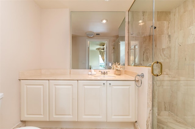 bathroom featuring vanity and a shower with door