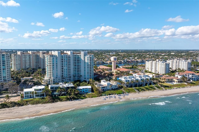 drone / aerial view featuring a water view and a view of the beach