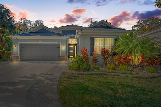 view of front of house with a garage and a lawn