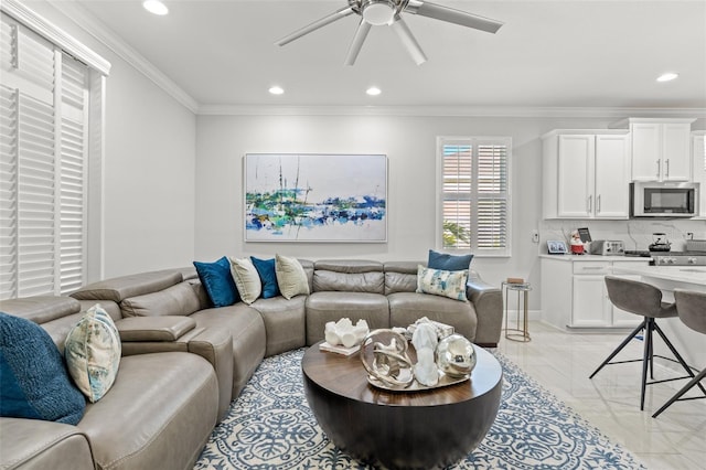 living room featuring ceiling fan and ornamental molding