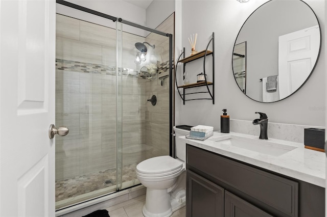 bathroom with vanity, toilet, and a shower with shower door