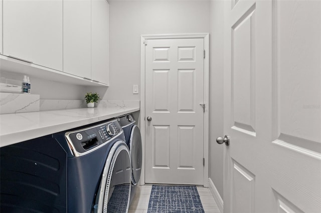 laundry area with cabinets and separate washer and dryer