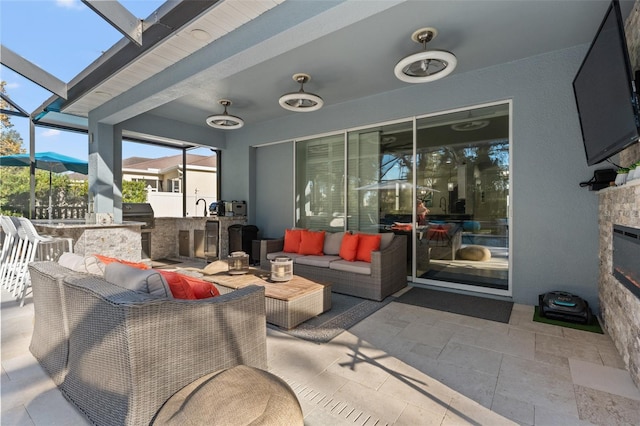 view of patio with area for grilling, an outdoor living space, exterior bar, and glass enclosure