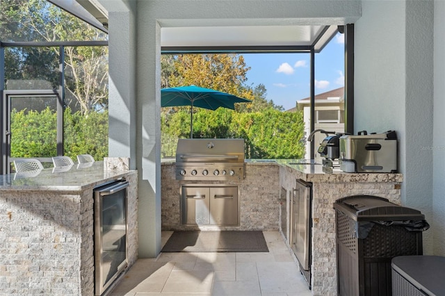 exterior space featuring glass enclosure, sink, beverage cooler, grilling area, and area for grilling