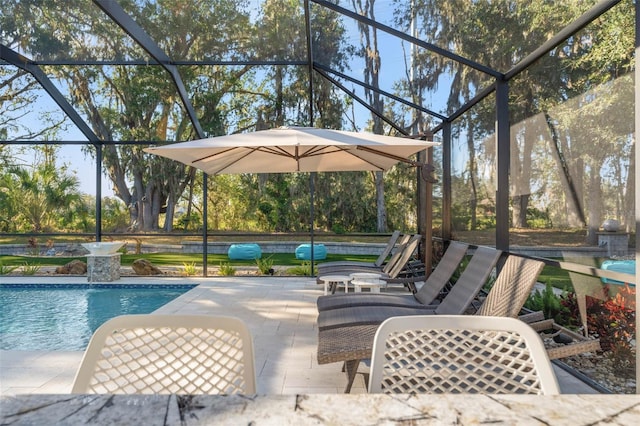 view of swimming pool featuring a lanai and a patio