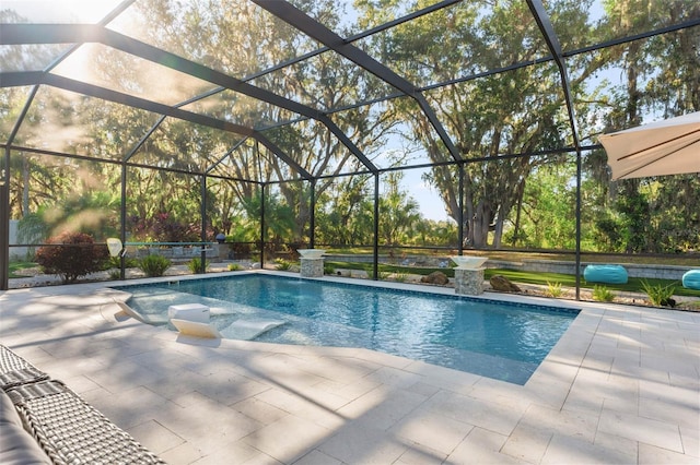 view of swimming pool with glass enclosure and a patio area