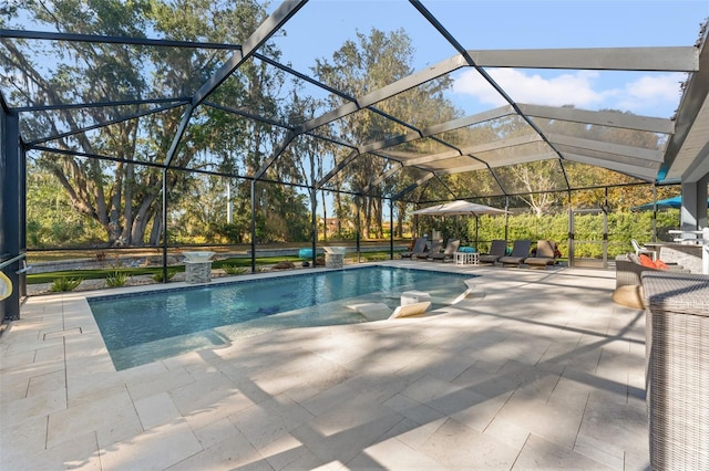 view of pool featuring glass enclosure and a patio