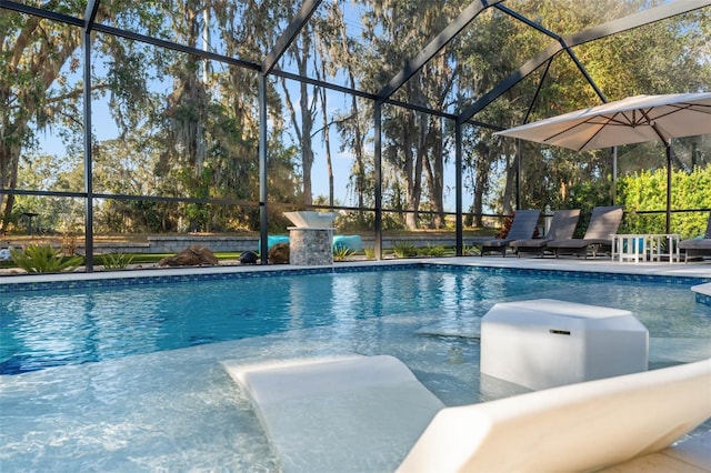 view of pool featuring glass enclosure and a patio area