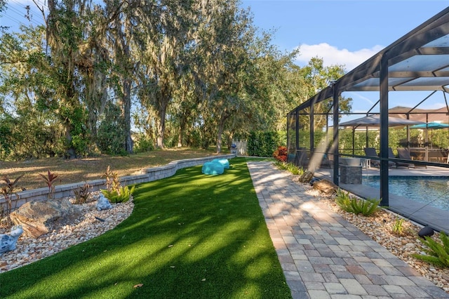 view of yard featuring glass enclosure