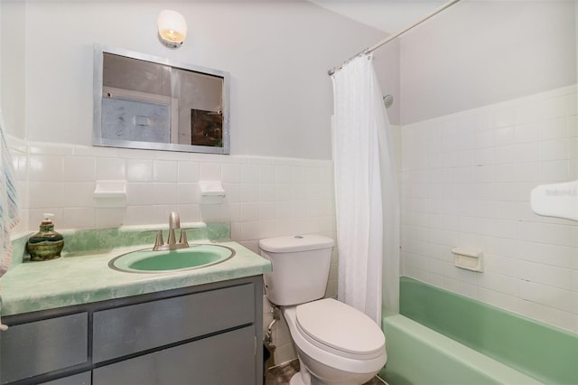 full bathroom featuring shower / tub combo, vanity, toilet, and tile walls