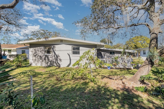 rear view of house featuring a yard