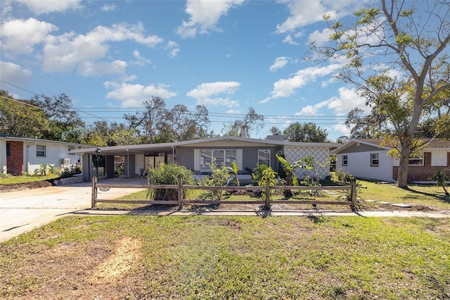 ranch-style home featuring a carport and a front yard