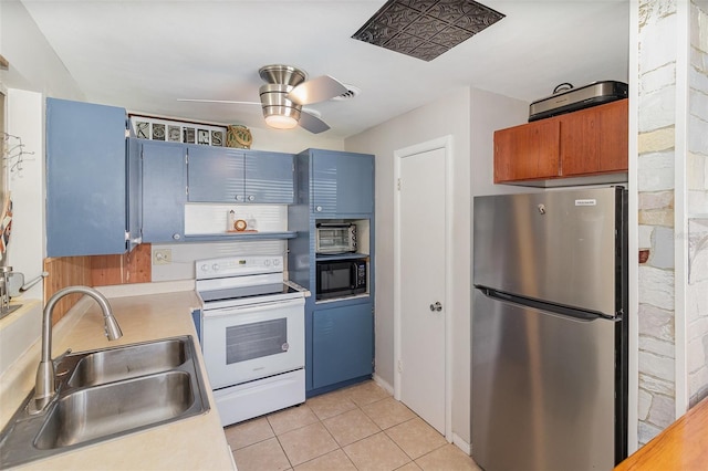 kitchen featuring stainless steel fridge, white range with electric stovetop, ceiling fan, sink, and light tile patterned flooring