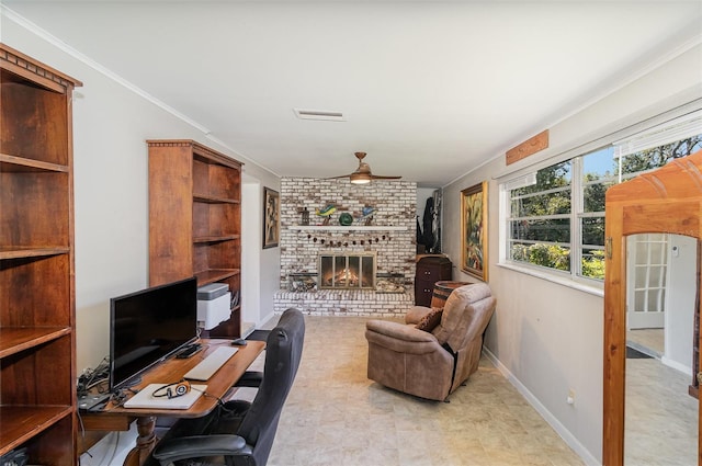 office space with ceiling fan, ornamental molding, and a brick fireplace