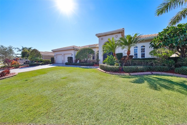 mediterranean / spanish-style house with a front yard and a garage