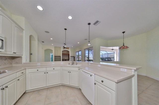 kitchen featuring white cabinetry, ceiling fan, tasteful backsplash, kitchen peninsula, and white appliances