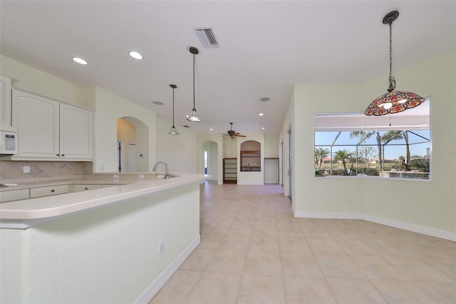 kitchen featuring sink, ceiling fan, decorative light fixtures, light tile patterned flooring, and white cabinetry