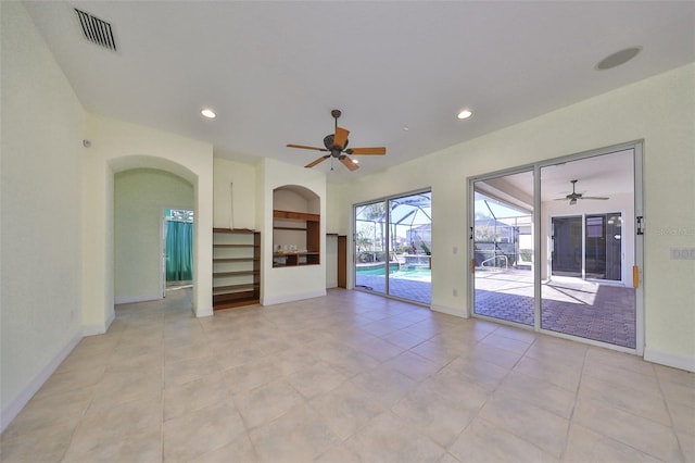 unfurnished living room with light tile patterned floors and ceiling fan