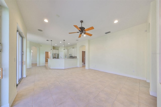 unfurnished living room featuring ceiling fan and light tile patterned floors