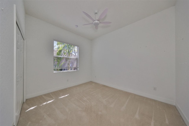 unfurnished bedroom featuring ceiling fan and light colored carpet