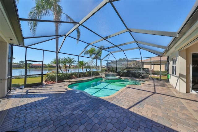 view of pool with a patio area, a lanai, an in ground hot tub, and a water view