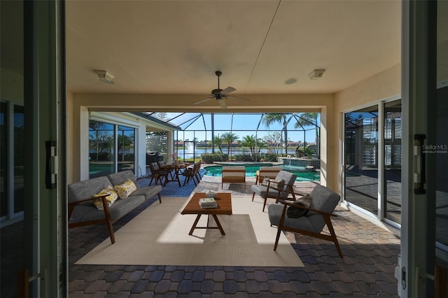 view of patio featuring an outdoor living space, glass enclosure, a water view, ceiling fan, and a swimming pool with hot tub