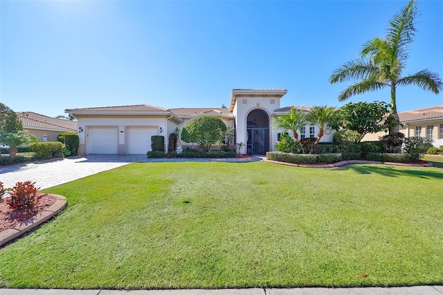 mediterranean / spanish house featuring a front yard and a garage