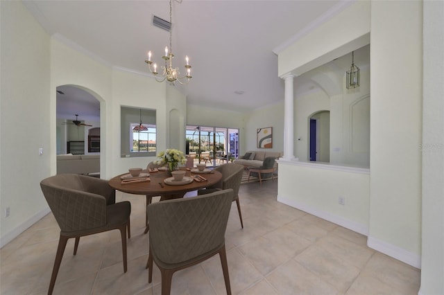 tiled dining area featuring ceiling fan with notable chandelier, ornate columns, and ornamental molding