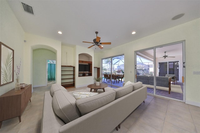 tiled living room featuring ceiling fan