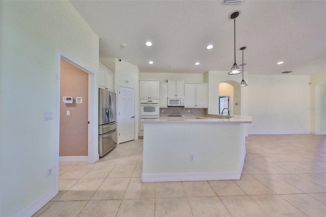 kitchen with white cabinetry, tasteful backsplash, stainless steel refrigerator with ice dispenser, decorative light fixtures, and light tile patterned floors