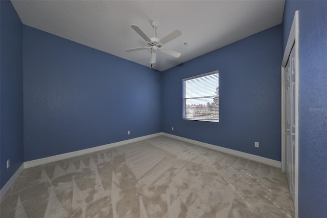 unfurnished bedroom with ceiling fan and light colored carpet