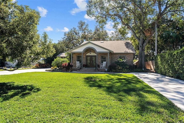 single story home with a front yard and french doors