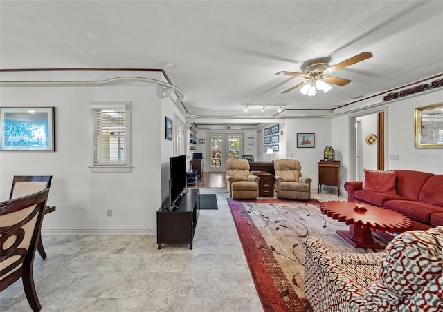 living room featuring french doors and ceiling fan