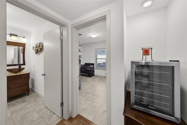 hallway with sink and wine cooler