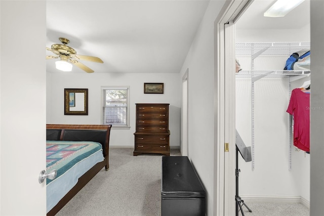 bedroom with ceiling fan and light colored carpet