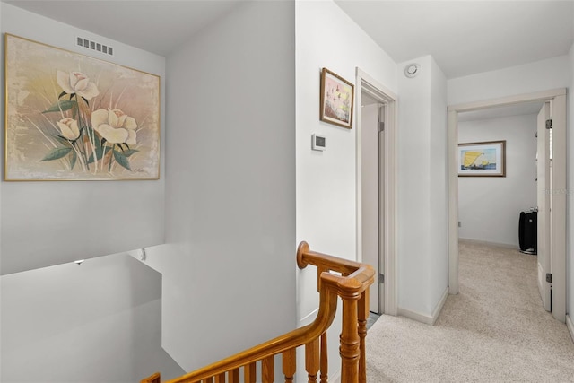 hallway with light colored carpet