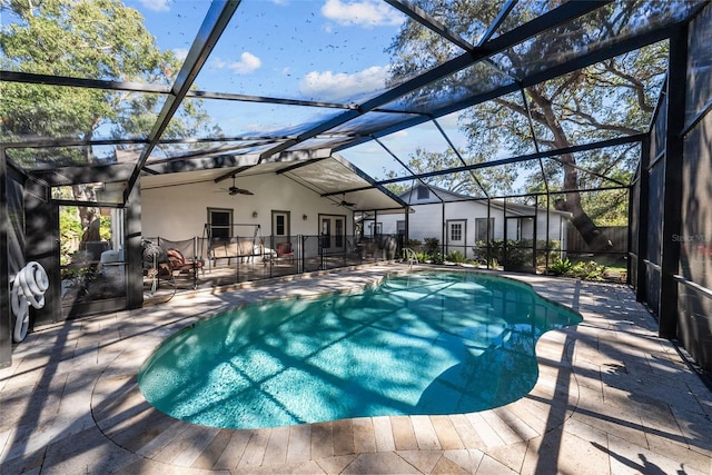 view of swimming pool featuring a lanai, ceiling fan, and a patio