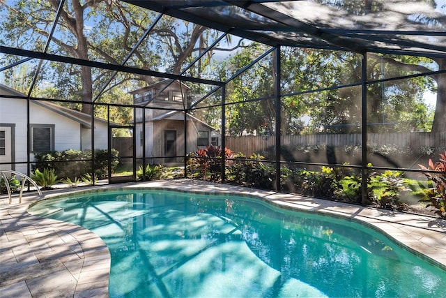 view of pool with a patio area, a lanai, and a shed