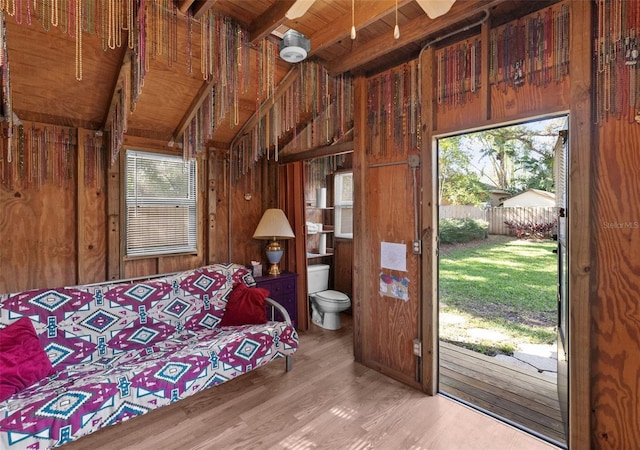 interior space with hardwood / wood-style floors, wood ceiling, wooden walls, and beam ceiling