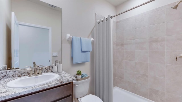 bathroom featuring curtained shower, vanity, and toilet