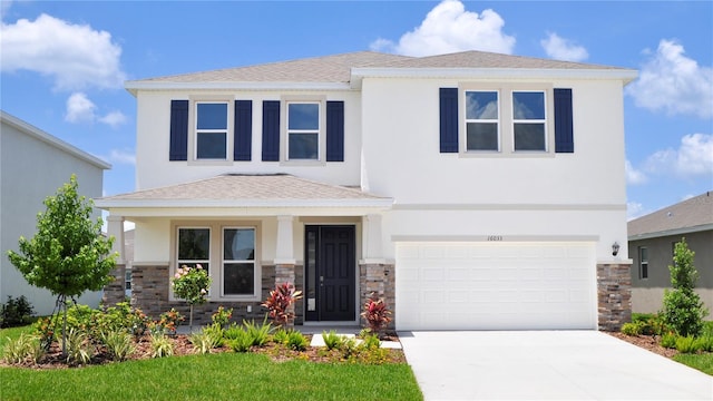 16033 7th Ave E, Bradenton, FL 34212 - view of front of home featuring stone siding, an attached garage, driveway, stucco siding, and roof with shingles