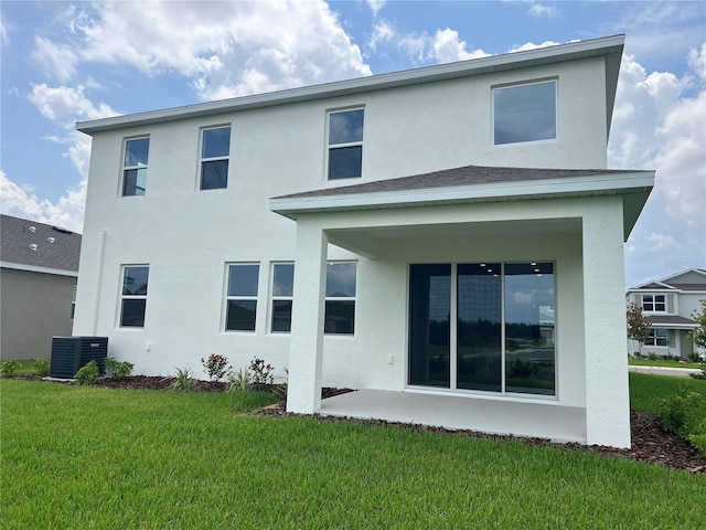16033 7th Ave E, Bradenton, FL 34212 - rear view of house featuring stucco siding, central air condition unit, a lawn, and a patio area