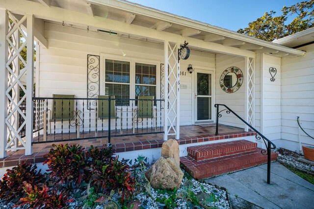 view of exterior entry featuring a porch