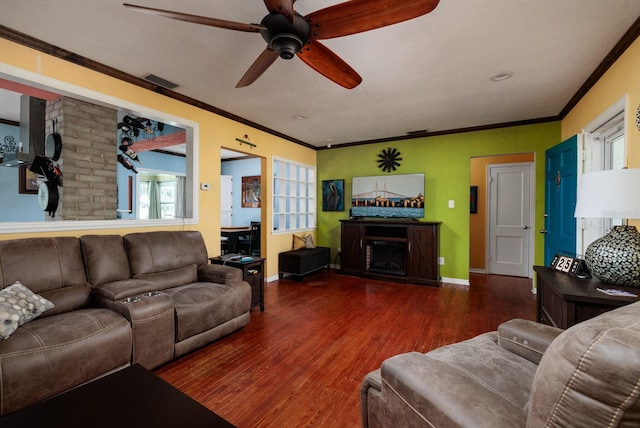 living room with ornamental molding, plenty of natural light, and dark wood-type flooring