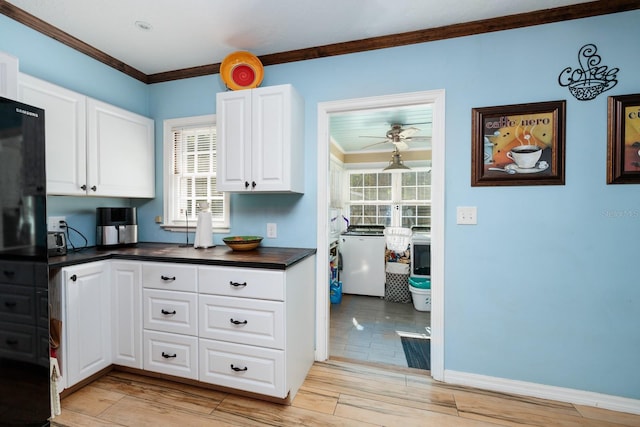 kitchen featuring white cabinets, light hardwood / wood-style floors, and crown molding