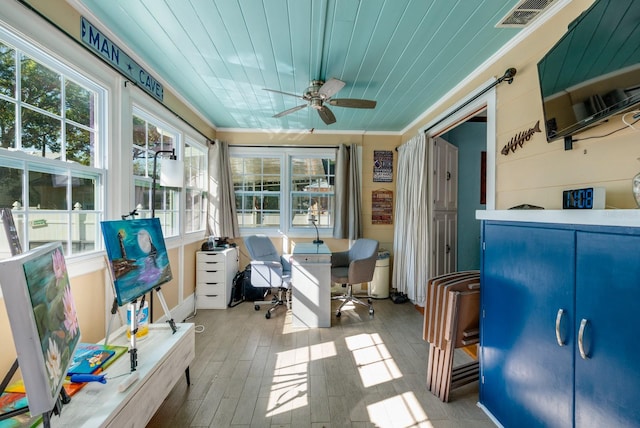 exterior space featuring ceiling fan, ornamental molding, and light wood-type flooring